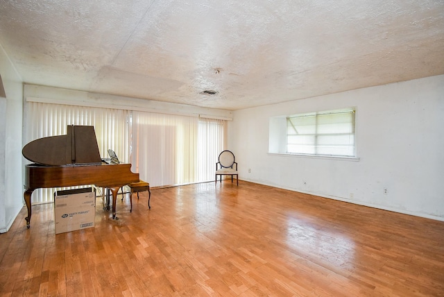 8602 Ariel St, Houston, TX 77074 - sitting room featuring hardwood / wood-style flooring, healthy amount of natural light, and a textured ceiling