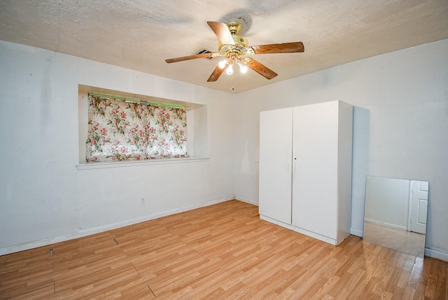 8602 Ariel St, Houston, TX 77074 - unfurnished bedroom with light wood-style floors, baseboards, and ceiling fan