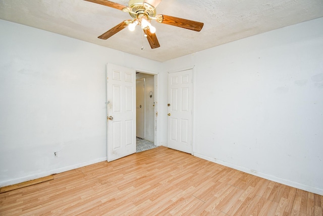 8602 Ariel St, Houston, TX 77074 - empty room with wood finished floors, baseboards, and ceiling fan