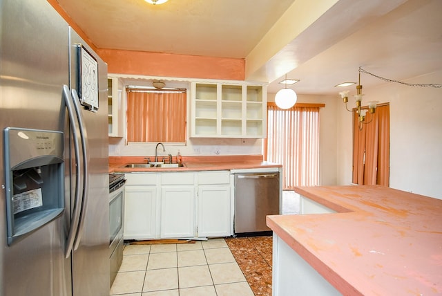 8602 Ariel St, Houston, TX 77074 - kitchen with stainless steel appliances, wooden counters, a sink, light tile patterned flooring, and white cabinetry