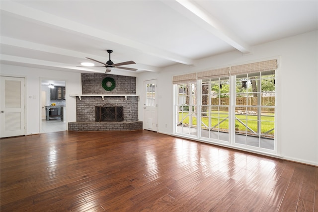 215 Whispering Oaks Dr, Taylor Lake Village, TX 77586 - unfurnished living room with beam ceiling, ceiling fan, healthy amount of natural light, and wood finished floors