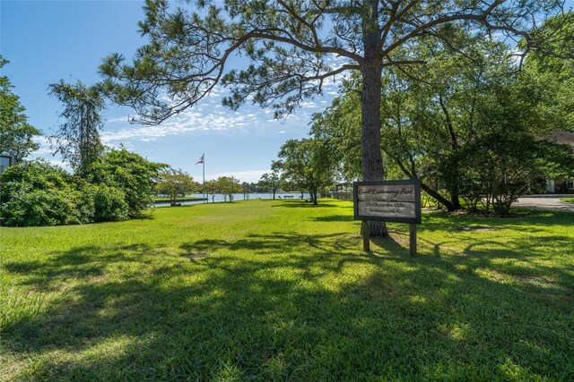 215 Whispering Oaks Dr, Taylor Lake Village, TX 77586 - view of green lawn featuring a water view