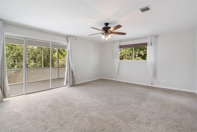 215 Whispering Oaks Dr, Taylor Lake Village, TX 77586 - unfurnished room with ceiling fan, healthy amount of natural light, carpet flooring, and baseboards
