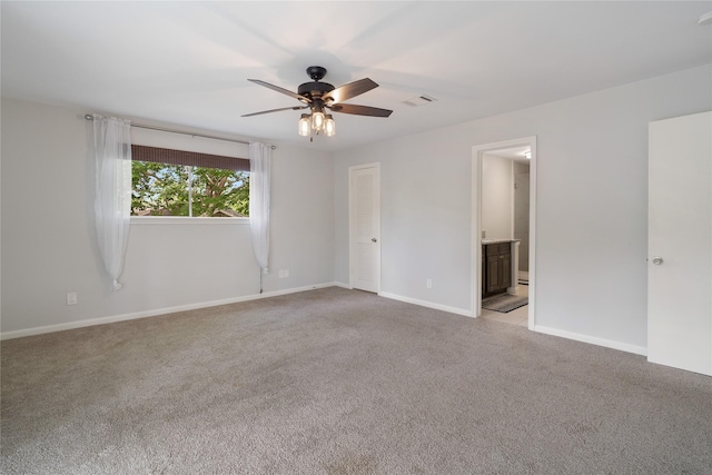 215 Whispering Oaks Dr, Taylor Lake Village, TX 77586 - spare room featuring a ceiling fan, light colored carpet, and baseboards