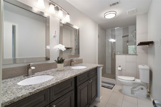 215 Whispering Oaks Dr, Taylor Lake Village, TX 77586 - bathroom featuring toilet, tile patterned floors, a shower stall, and double vanity