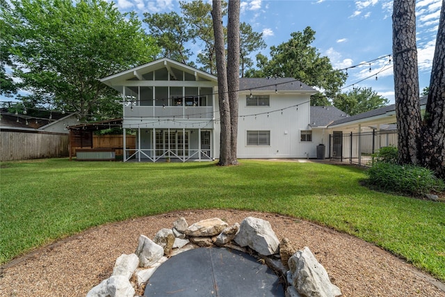 215 Whispering Oaks Dr, Taylor Lake Village, TX 77586 - back of house featuring a sunroom and a hot tub