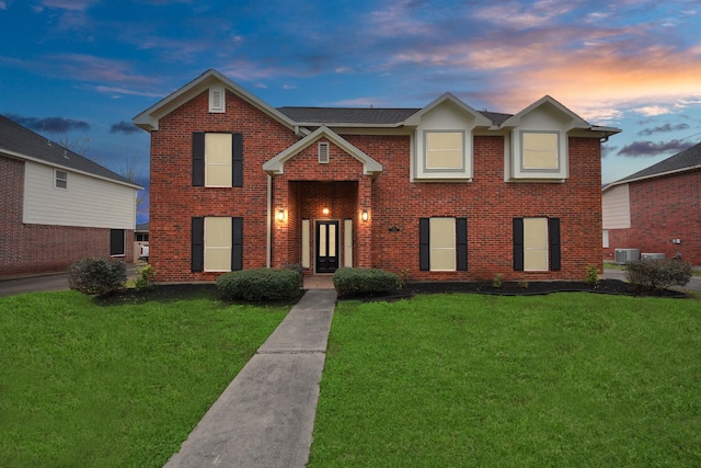 1410 Long View Dr, Pearland, TX 77581 - traditional home featuring brick siding, a front lawn, and cooling unit