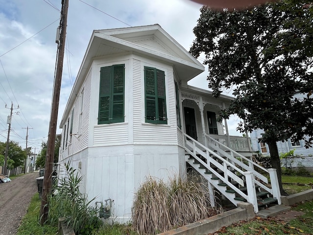 614 18th St, Galveston, TX 77550 - view of home's exterior featuring covered porch and stairway