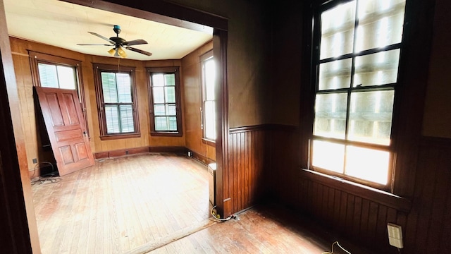 614 18th St, Galveston, TX 77550 - empty room featuring light wood-type flooring, a ceiling fan, and a wainscoted wall