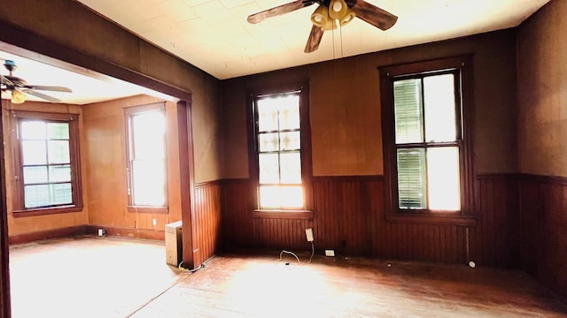 614 18th St, Galveston, TX 77550 - spare room featuring ceiling fan, a wainscoted wall, wood finished floors, and wood walls