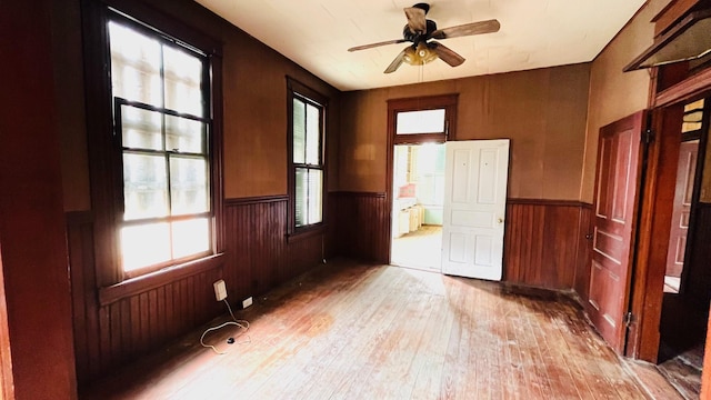 614 18th St, Galveston, TX 77550 - unfurnished room featuring wainscoting, hardwood / wood-style flooring, a ceiling fan, and wood walls