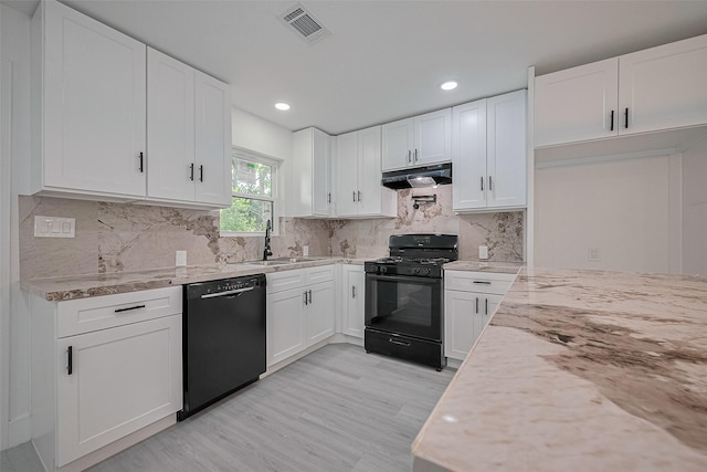 15622 Corsair Rd, Houston, TX 77053 - kitchen with black appliances, a sink, under cabinet range hood, light wood finished floors, and light stone counters