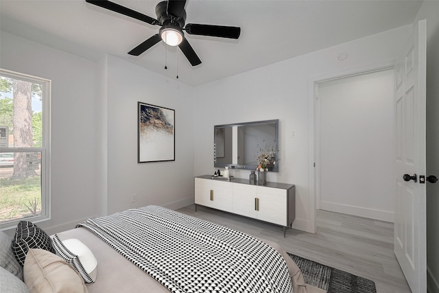 15622 Corsair Rd, Houston, TX 77053 - bedroom featuring baseboards, light wood-style floors, and a ceiling fan