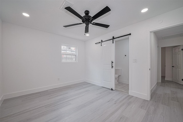 15622 Corsair Rd, Houston, TX 77053 - unfurnished bedroom with light wood-style flooring, a barn door, baseboards, recessed lighting, and ceiling fan