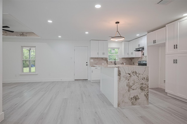 15622 Corsair Rd, Houston, TX 77053 - kitchen with light wood-style flooring, range, white cabinetry, and recessed lighting