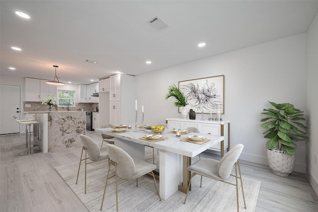 15622 Corsair Rd, Houston, TX 77053 - dining room featuring light wood-type flooring, recessed lighting, and baseboards