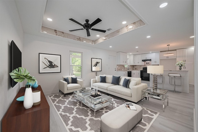 15622 Corsair Rd, Houston, TX 77053 - living area featuring ceiling fan, light wood-type flooring, recessed lighting, a raised ceiling, and baseboards
