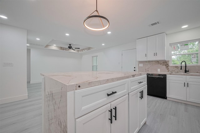 15622 Corsair Rd, Houston, TX 77053 - kitchen with black dishwasher, a sink, light wood-type flooring, light stone countertops, and a kitchen island