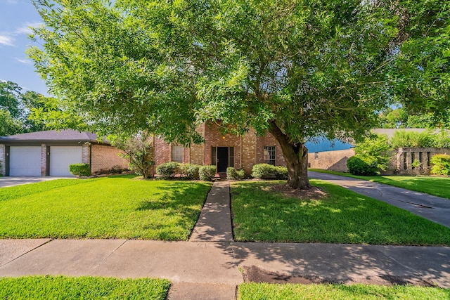 7631 Southmeadow Dr, Houston, TX 77071 - view of front facade featuring brick siding, a front yard, driveway, and an attached garage