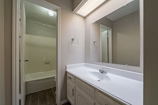 7631 Southmeadow Dr, Houston, TX 77071 - bathroom featuring wood finished floors, vanity, toilet, and washtub / shower combination