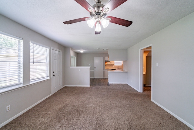7631 Southmeadow Dr, Houston, TX 77071 - unfurnished living room with dark colored carpet, ceiling fan, baseboards, and a textured ceiling