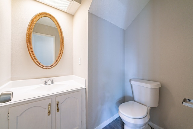 7631 Southmeadow Dr, Houston, TX 77071 - half bath with toilet, vanity, baseboards, and lofted ceiling