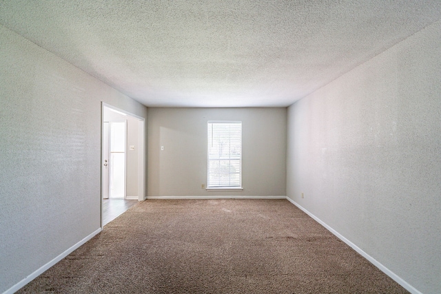 7631 Southmeadow Dr, Houston, TX 77071 - empty room with a textured wall, carpet flooring, and baseboards