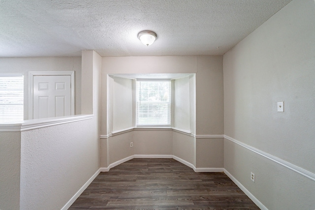 7631 Southmeadow Dr, Houston, TX 77071 - spare room featuring dark wood-style floors, a textured ceiling, and baseboards