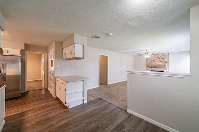 7631 Southmeadow Dr, Houston, TX 77071 - kitchen with appliances with stainless steel finishes, ceiling fan, dark wood finished floors, baseboards, and white cabinets