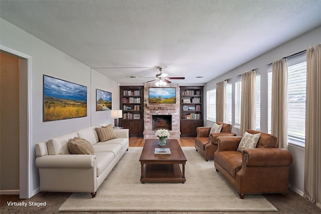 7631 Southmeadow Dr, Houston, TX 77071 - living area featuring a ceiling fan, a fireplace, baseboards, and built in features