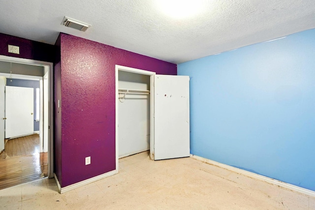 2005 Worms St, Houston, TX 77020 - unfurnished bedroom with a textured ceiling, a closet, and baseboards