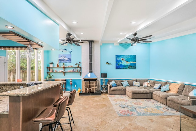 3415 80th St, Galveston, TX 77551 - living area with recessed lighting, a wood stove, a ceiling fan, and light tile patterned flooring