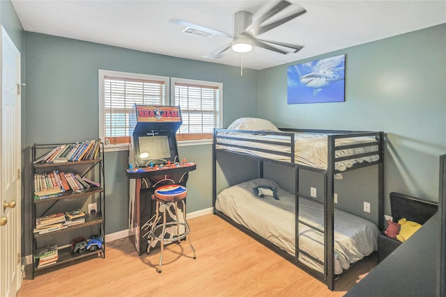 3415 80th St, Galveston, TX 77551 - bedroom with wood finished floors, baseboards, and ceiling fan