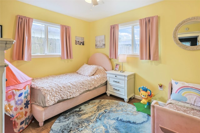 3415 80th St, Galveston, TX 77551 - bedroom with dark wood-style flooring, multiple windows, and baseboards