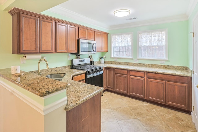3415 80th St, Galveston, TX 77551 - kitchen featuring stainless steel appliances, a sink, light stone counters, ornamental molding, and a peninsula