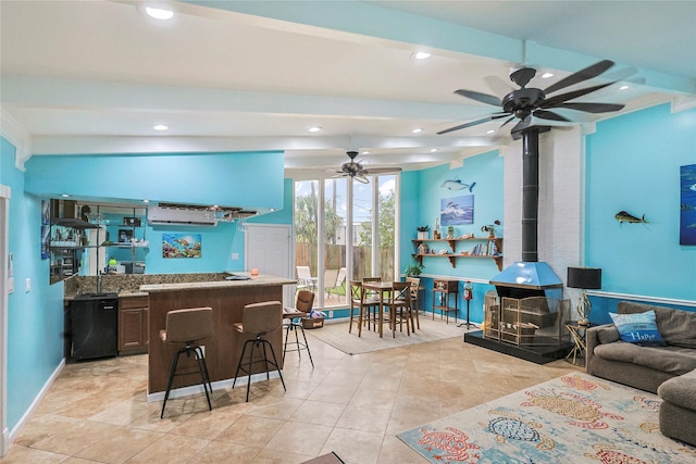 3415 80th St, Galveston, TX 77551 - kitchen featuring ceiling fan, a wood stove, recessed lighting, light tile patterned floors, and open floor plan