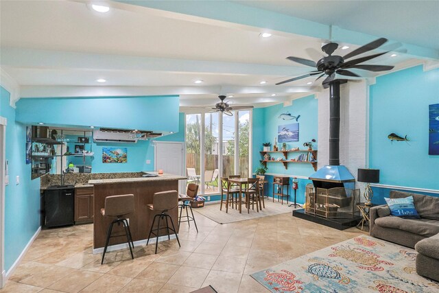 3415 80th St, Galveston, TX 77551 - kitchen with a wood stove, a ceiling fan, recessed lighting, light tile patterned floors, and open floor plan