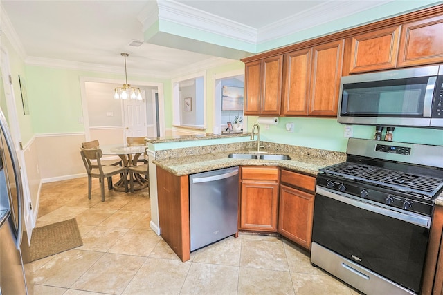 3415 80th St, Galveston, TX 77551 - kitchen with stainless steel appliances, a sink, brown cabinets, a chandelier, and a peninsula