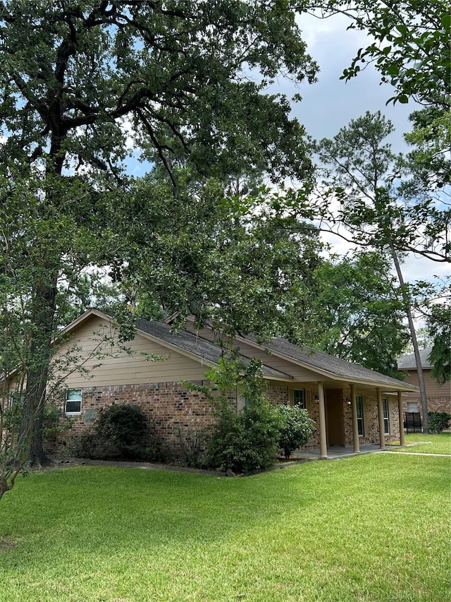 203 Ridgewood Dr, Spring, TX 77386 - view of side of home with a yard and brick siding