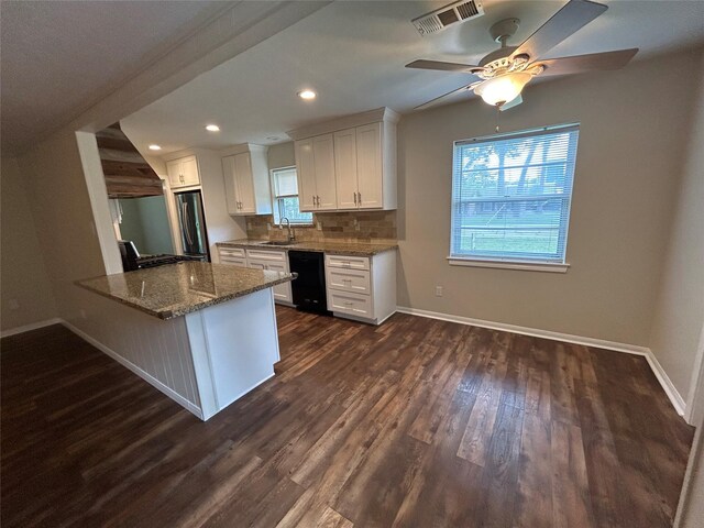 203 Ridgewood Dr, Spring, TX 77386 - kitchen with black dishwasher, white cabinetry, dark wood-type flooring, wall chimney range hood, and stone countertops
