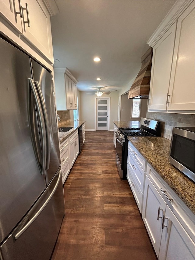203 Ridgewood Dr, Spring, TX 77386 - kitchen featuring stainless steel appliances, custom range hood, recessed lighting, backsplash, and dark stone counters