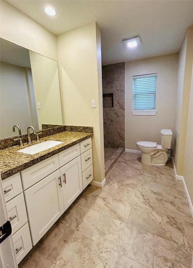 203 Ridgewood Dr, Spring, TX 77386 - bathroom with tiled shower, vanity, and marble look tile flooring