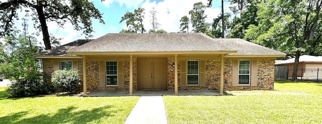 203 Ridgewood Dr, Spring, TX 77386 - view of front of house featuring brick siding, roof with shingles, and a patio