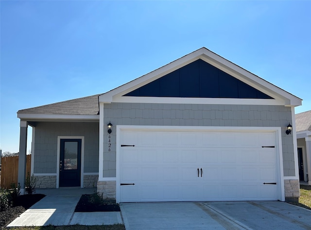 6426 Summer Pass Dr, Houston, TX 77048 - ranch-style house with stone siding, an attached garage, driveway, and a shingled roof