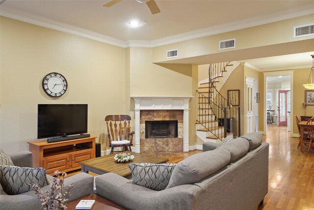 606 E 27th St, Houston, TX 77008 - living area with stairs, a premium fireplace, crown molding, wood finished floors, and a ceiling fan
