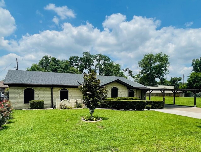 7635 Nordling Rd, Houston, TX 77037 - single story home with concrete driveway, a front yard, brick siding, and a shingled roof