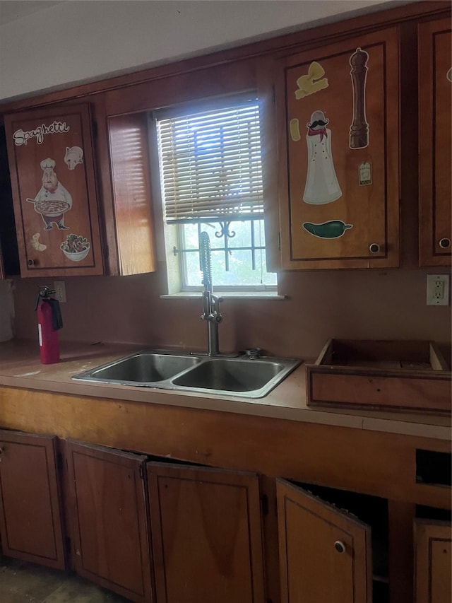 3419 Dennis St, Houston, TX 77004 - kitchen featuring a sink, light countertops, and brown cabinetry
