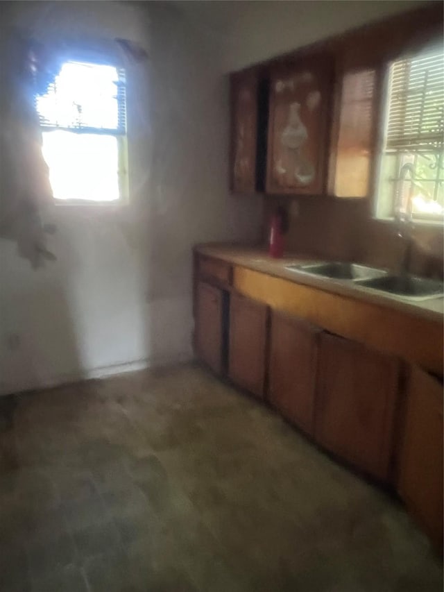 3419 Dennis St, Houston, TX 77004 - kitchen with light countertops, brown cabinetry, and a sink