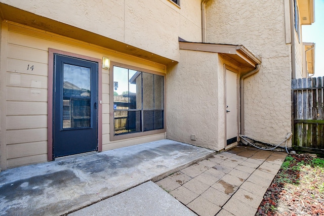 5001 Lamonte Ln Unit 14, Houston, TX 77092 - doorway to property featuring stucco siding and a patio area