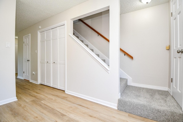 5001 Lamonte Ln Unit 14, Houston, TX 77092 - stairs featuring a textured ceiling, wood finished floors, and baseboards
